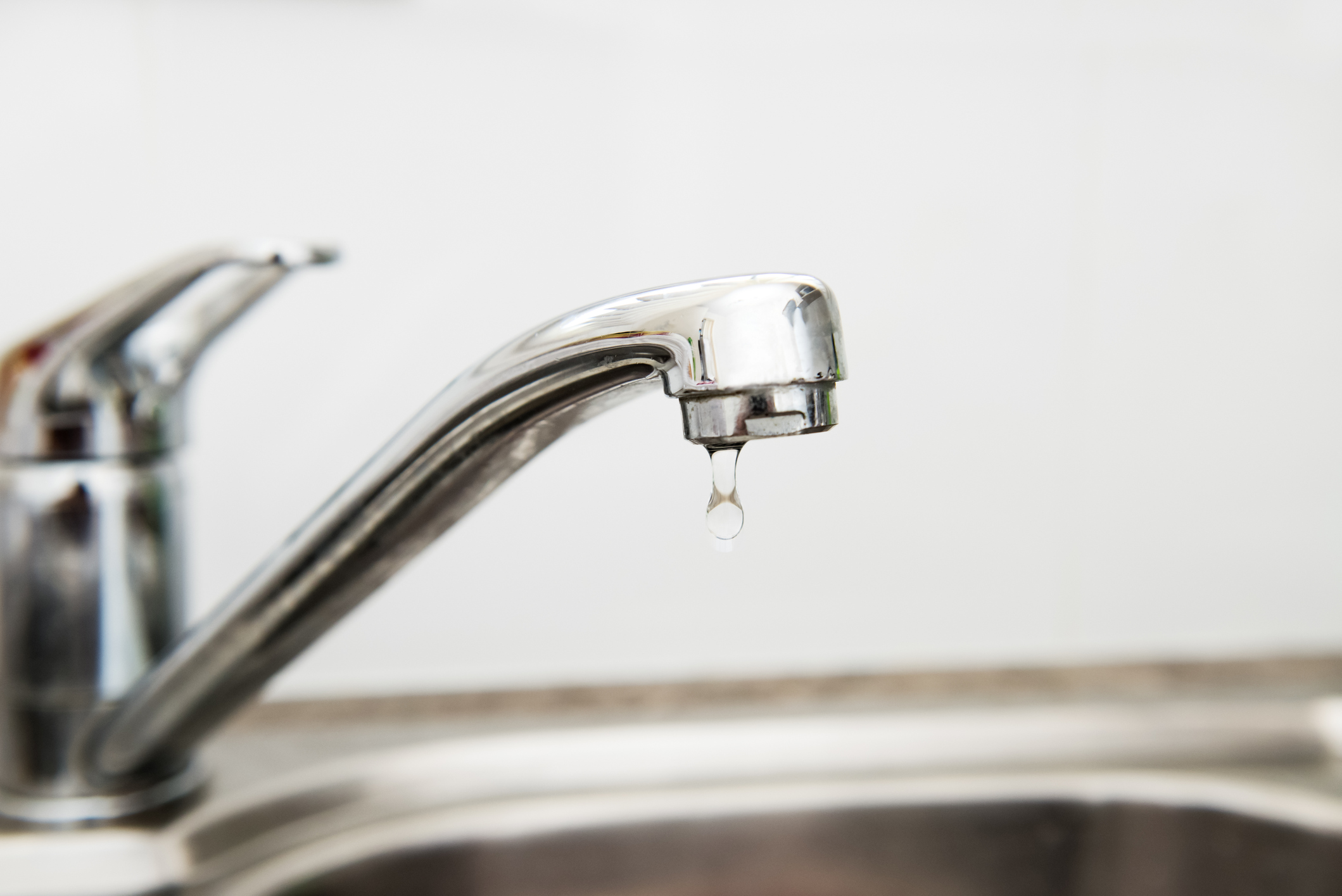 Modern stainless steel faucet leaking and dripping water