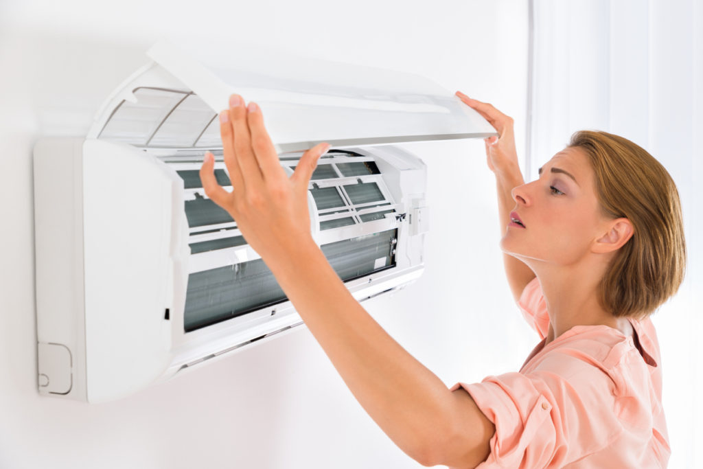 Woman opening ductless AC