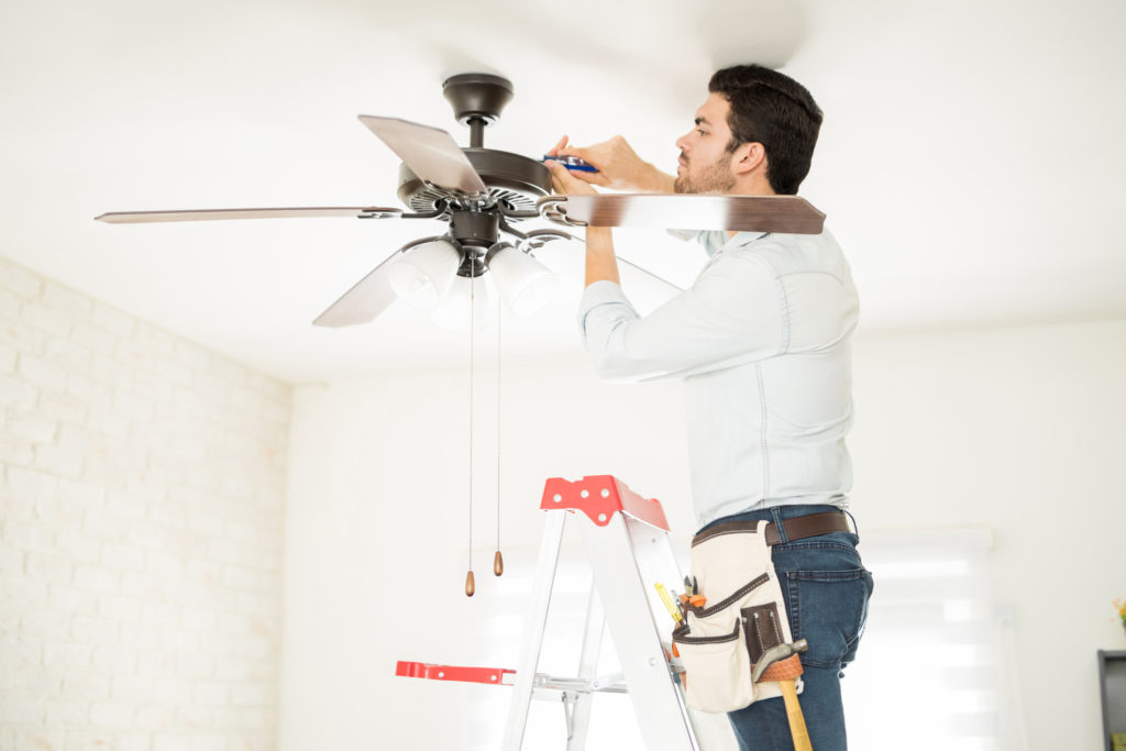 Handyman installing a ceiling fan