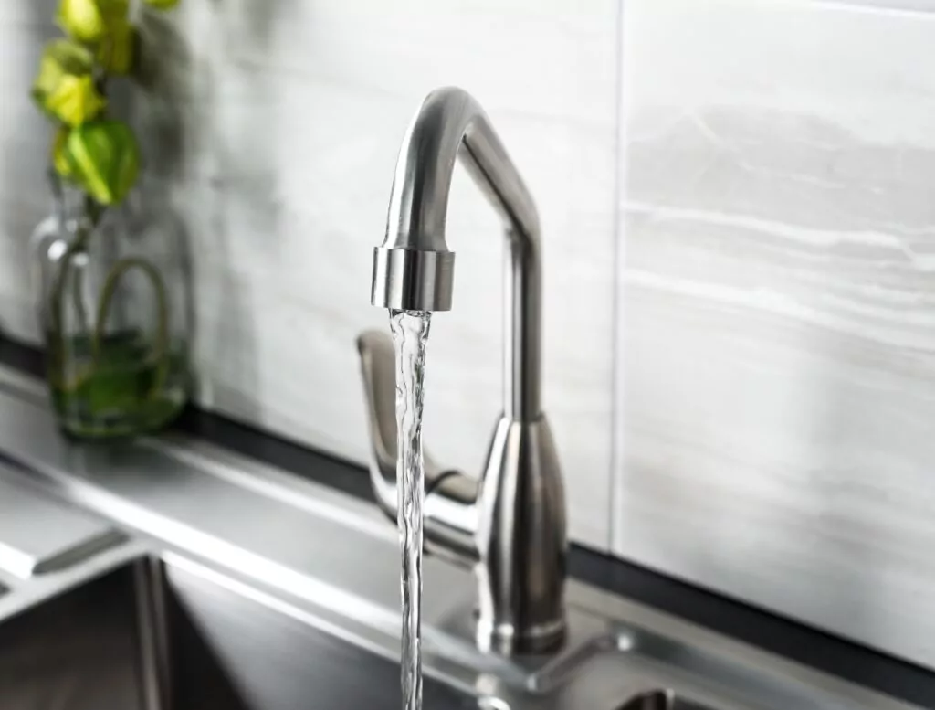 The new and  modern steel faucet in the kitchen