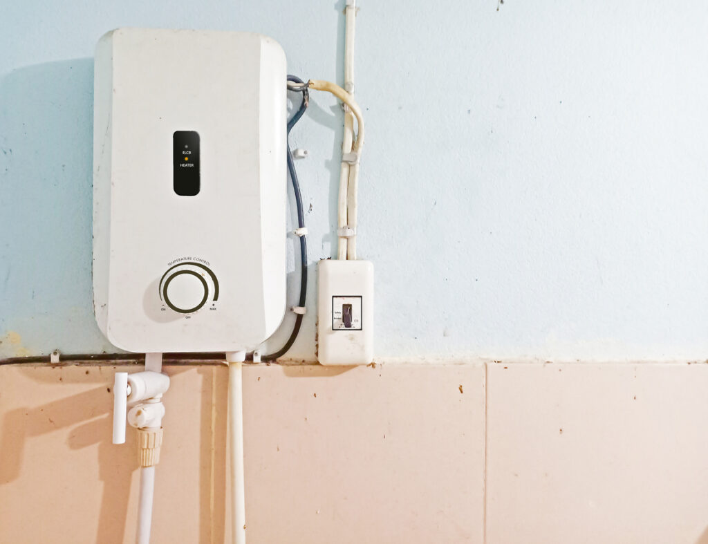 White tankless water heater installed on the wall of bathroom