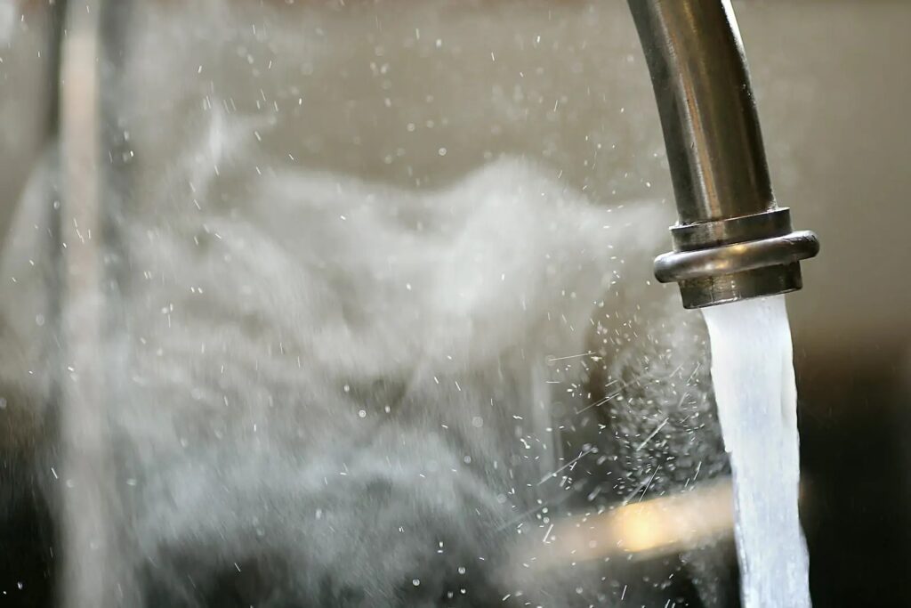 hot faucet pouring water