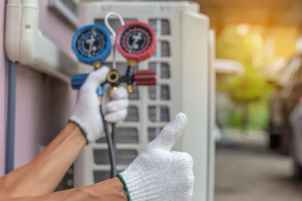 Technician checking the pressure of an AC unit