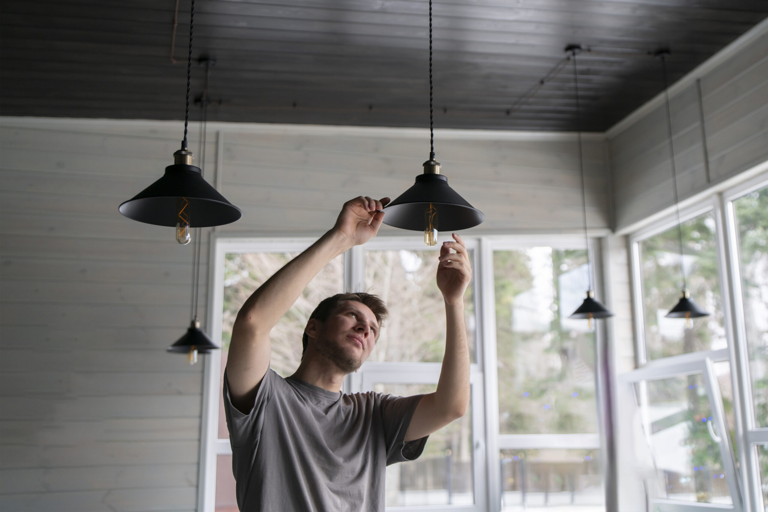 Homeowner looking at a light fixture